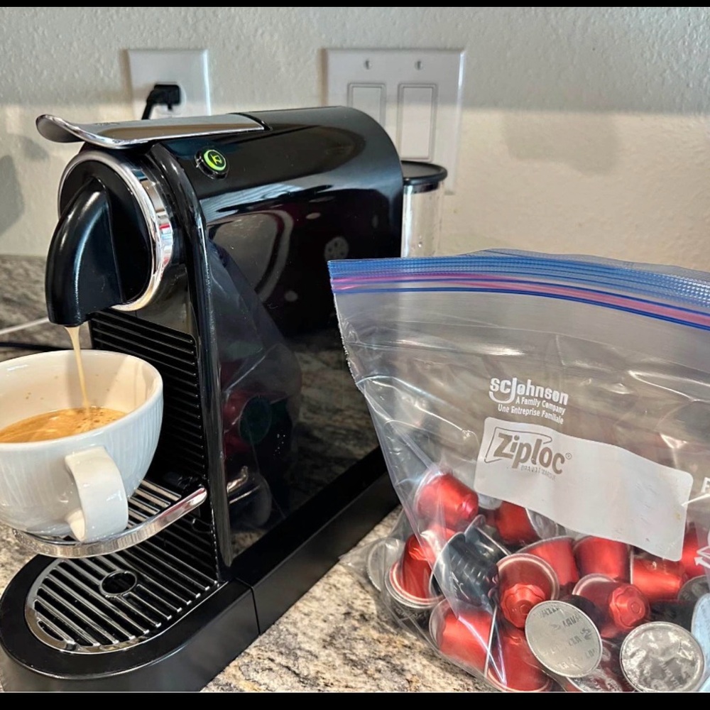 Nespresso Black Coffee Machine with Red Capsules